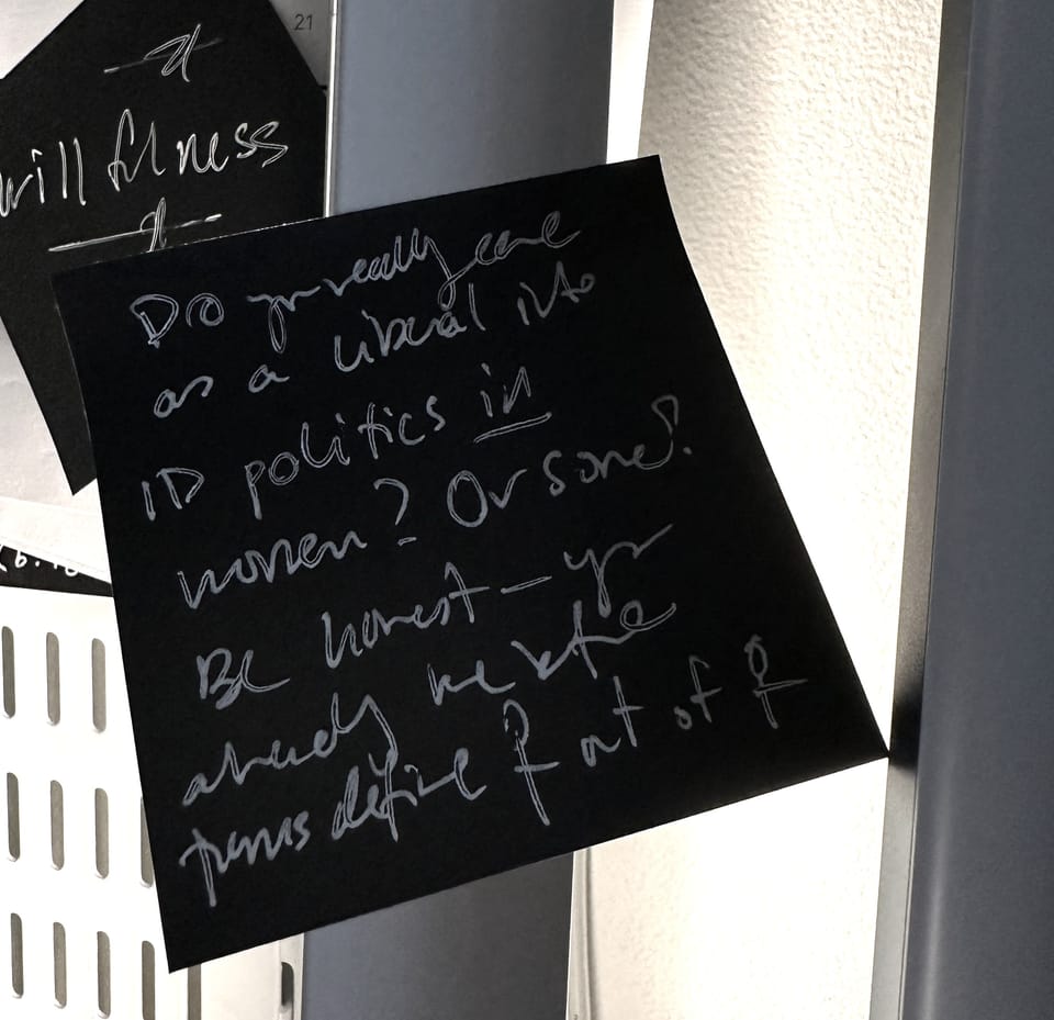 white ink on a black Post-it I can barely decipher right now, the gist being: what's the point of "protecting women"